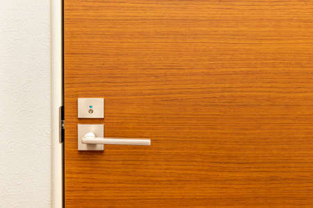 Wooden door with metal knobの写真素材
