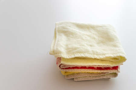 Towels stacked on a white tableの写真素材