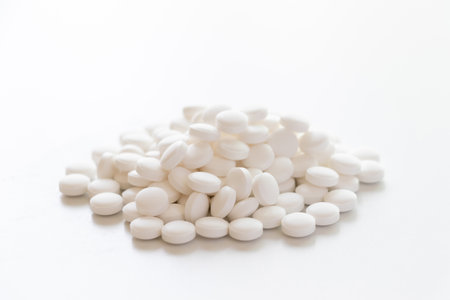 Lots of white tablets piled up on the tableの写真素材