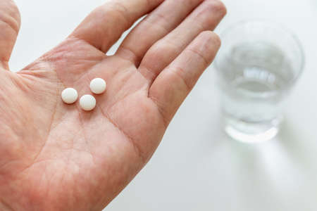 Place the white tablets on the palmの写真素材