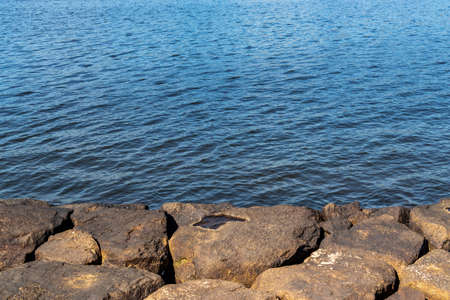 Calm blue sea surface seen from the quay