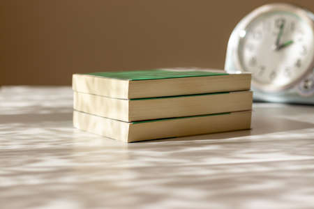 Three books stacked on the deskの写真素材