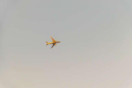 An airplane flying in the dusk sky