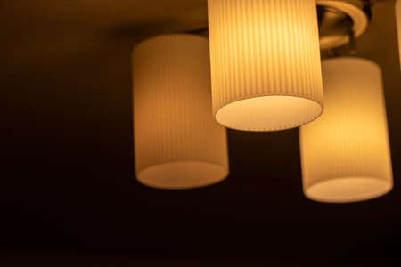 Orange lighting mounted on the ceilingの写真素材