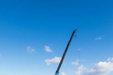 A crane that stretches the boom toward the skyの写真素材