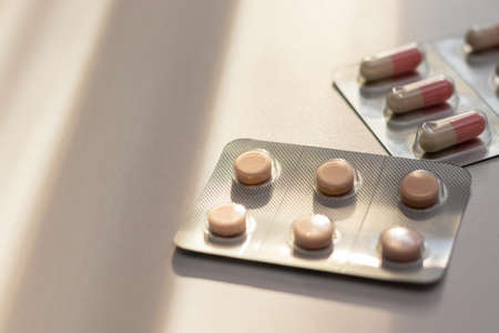 Tablets and capsules on the table in the eveningの写真素材