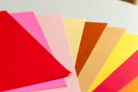 Warm color papers on the white tableの写真素材
