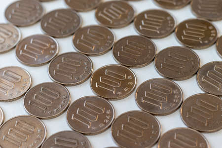 Lots of 100-yen coins on the deskの写真素材