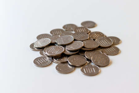 Lots of Japanese 100-yen coins piled on the deskの写真素材