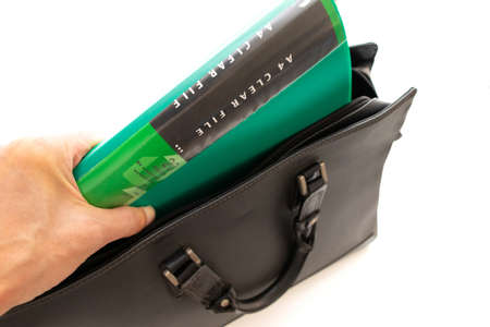 Take out the green file from the black business bag