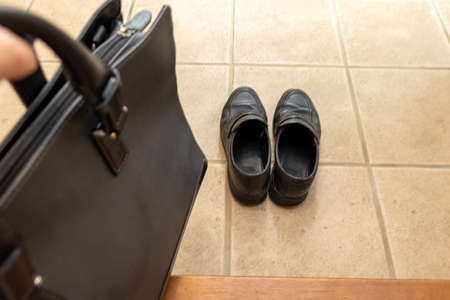 Black business shoes on the floor at the entranceの写真素材