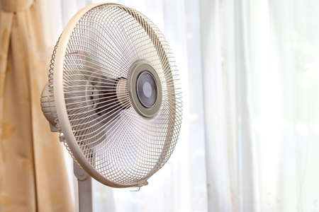A fan by the windowの写真素材