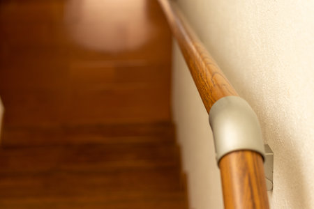Wooden railing on the white wall by the stairsの写真素材