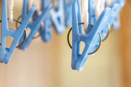 Plastic clothespins hanging in the roomの写真素材
