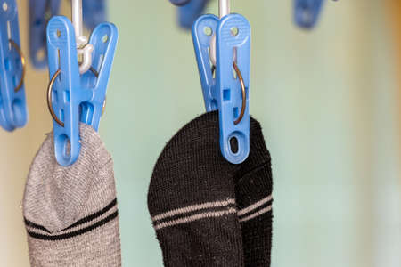 Socks hanging with clothespins in the room