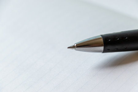 White notebook and ballpoint pen tipの写真素材