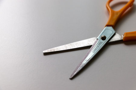 Stainless steel scissors on white tableの写真素材