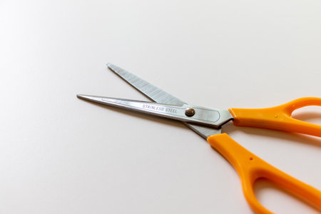 Stainless steel scissors on white tableの写真素材