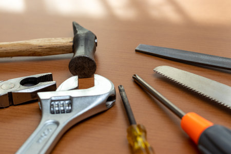 Various tools on the wooden workbench by the window