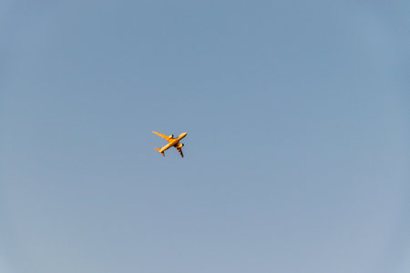 The orange shining airplane in the dusk skyの写真素材