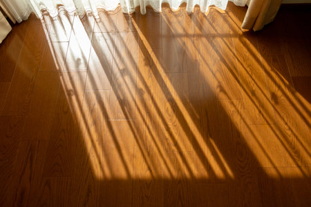 The shadow of the curtain that fell on the floor of the roomの写真素材