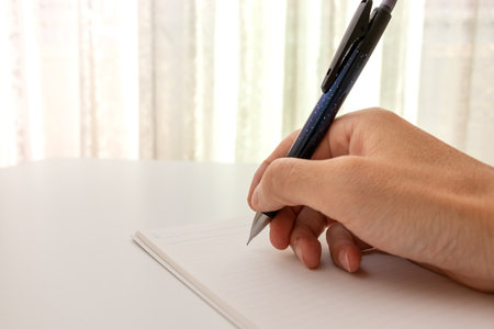 Write something in a notebook with a mechanical pencil