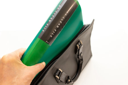 Take out the green file from the black business bagの写真素材
