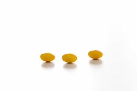 Three yellow tablets on the white table