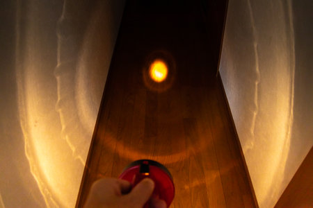 Light up the dark hallway with a flashlightの写真素材