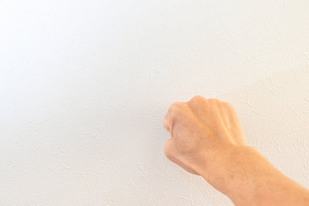 Stick right fist at the wallの写真素材