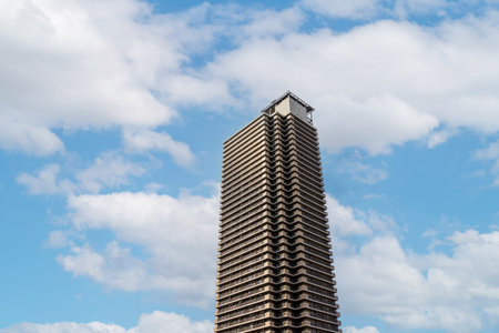 High rise building under blue sky with white cloud