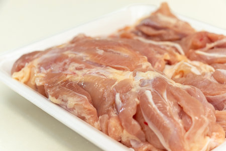 Raw chicken on a plastic trayの写真素材