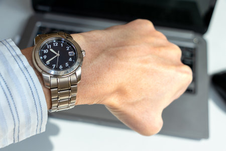 check the time while working on a computerの写真素材