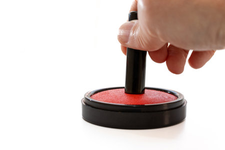 Japanese seal pressed against a red ink padの写真素材