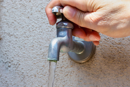 turn the handle of the water faucetの写真素材