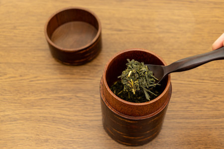 Japanese tea in a pot on a wooden table, close-upの写真素材