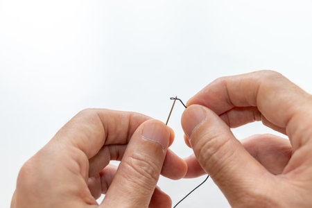 thread through the small hole in a fine needleの写真素材