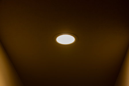 A small light in the ceiling that illuminates the corridorの写真素材