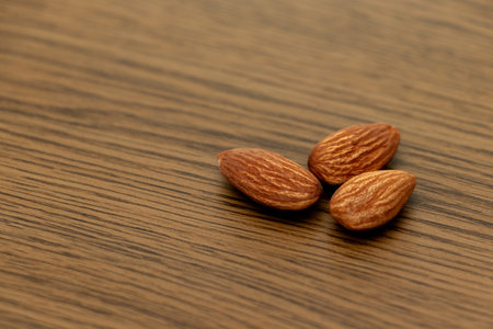 Almonds on wooden background. Close up. Selective focus.の写真素材