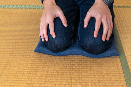 A man sitting seiza on a cushion in the Japanese roomの写真素材