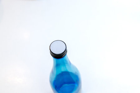 Blue bottle on white background with copy space for textの写真素材