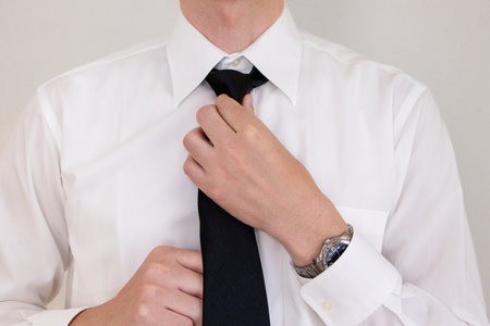 A man in a white shirt wearing a black tieの写真素材