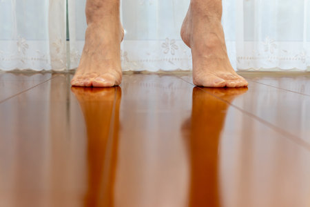 Standing on tiptoes on a wooden floorの写真素材