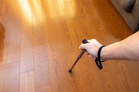 Using a walking stick on a wooden floor