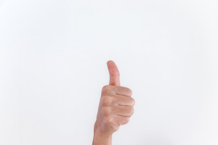 Thumbs up hand sign on white backgroundの写真素材