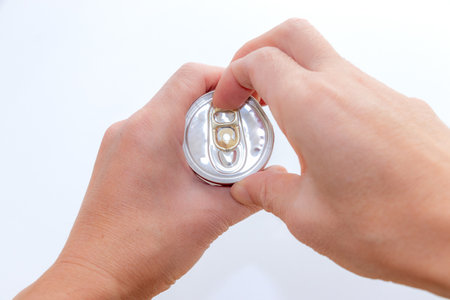 Pulling the tab on a can of drinkの写真素材