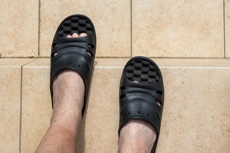 Man's feet wearing sandals outdoors