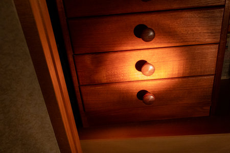 Open the drawer while illuminating the chestの写真素材