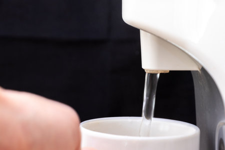 pour hot water into a mugの写真素材