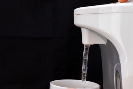 pour hot water into a mugの写真素材